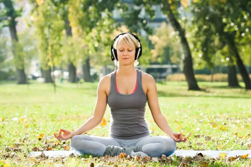 Woman meditating with music